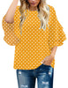 Front view of model wearing yellow polka dots trumpet sleeves keyhole-back blouse